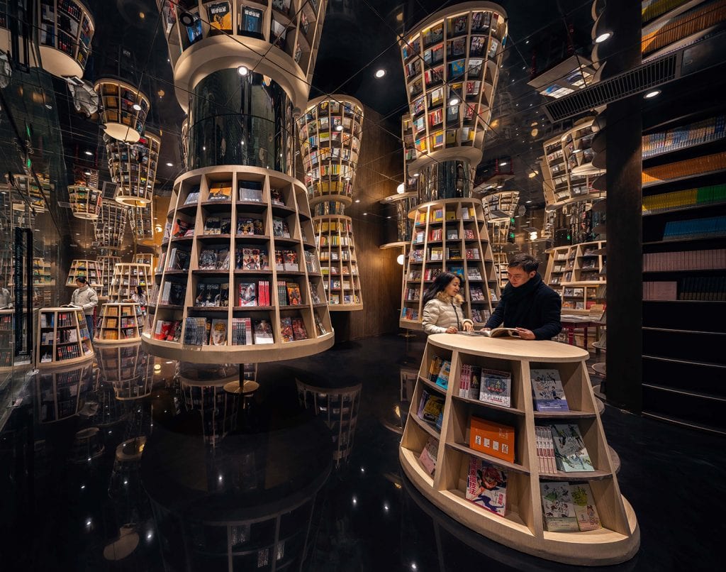 Lampshade-shaped bookshelves greet visitors inside the store